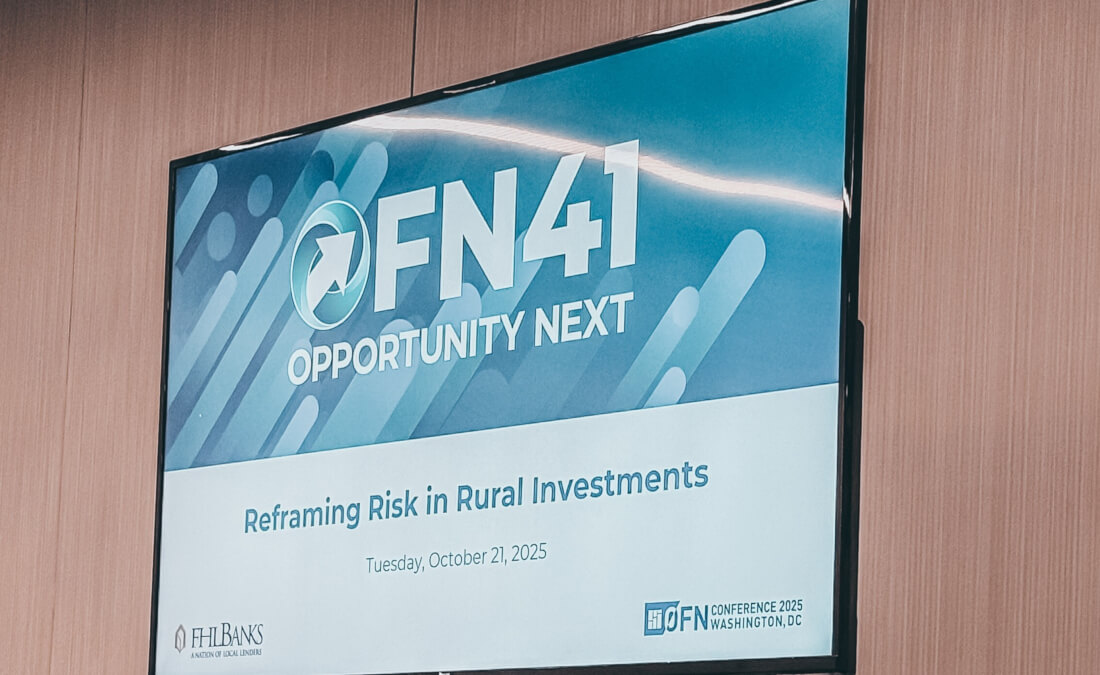 A television screen displaying a conference slide titled “OFN41 Opportunity Next – Reframing Risk in Rural Investments.”